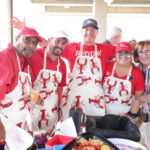Group wearing lobster aprons at outdoor event.