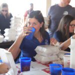 People enjoying a meal with drinks outdoors.