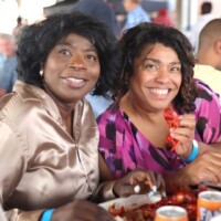 Two women enjoying a seafood meal together.