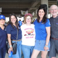 Group of five people smiling together.