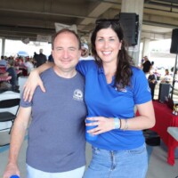 Two people smiling at a casual event.