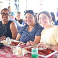 Three friends enjoying a meal together.