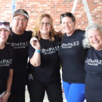Group of people in matching black shirts.
