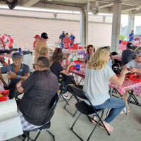 People enjoying a meal at a gathering.