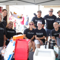 Group of people wearing matching black shirts.