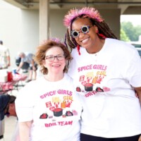Two women wearing Spice Girls Boil Team shirts.