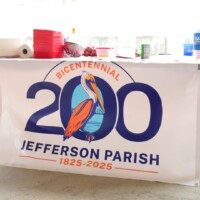 Jefferson Parish Bicentennial banner on table.
