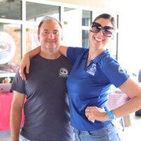 Smiling people posing together outdoors.