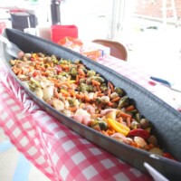 Seafood and vegetables in a large container.
