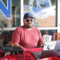 Man sitting at table with laptop.