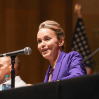 Woman speaking at a panel discussion event.