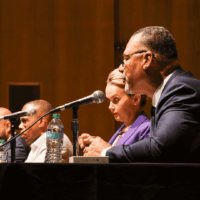 Panel discussion with four people speaking.