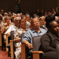 Audience attentively listening in a theater.