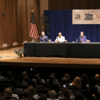 Panel discussion with audience and speakers on stage.