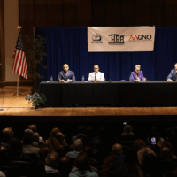 Panel discussion in a conference hall setting.