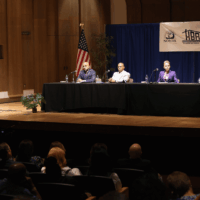 Panel discussion with audience in auditorium.