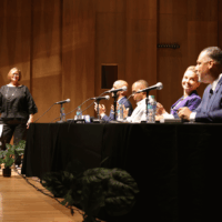 Panel discussion with five people on stage.