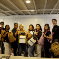 Smiling volunteers standing with backpacks